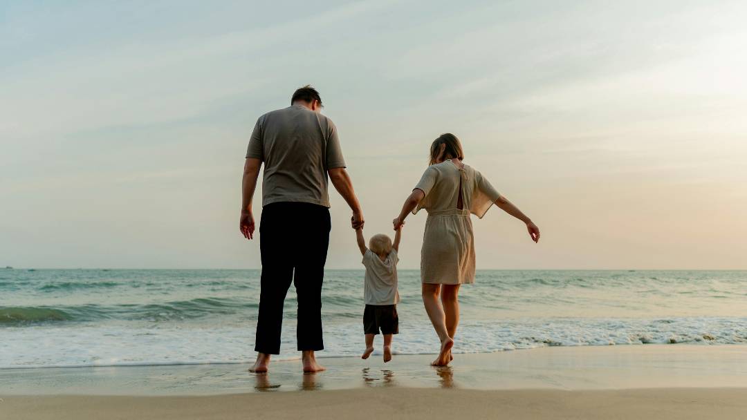 Key Person Protection for your Business. Scenic picture of Dorset beach with a family walking towards the sea.