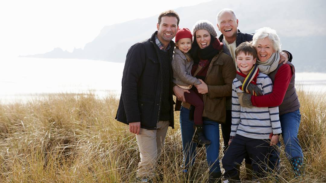 Life Insurance and Critical Illness Cover. Family out walking in the Dorset countryside, posing for a group photo.